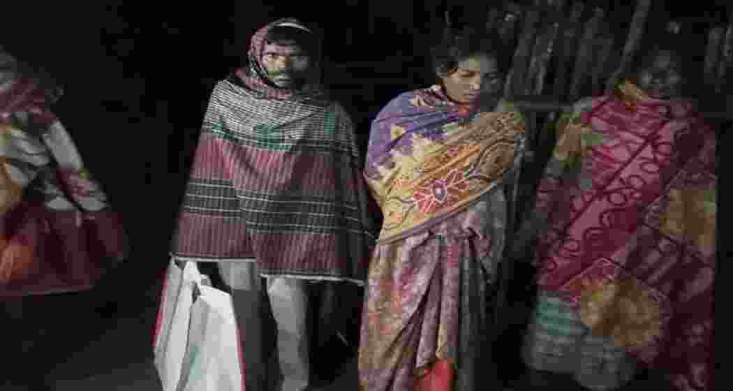 Grieving family members carry the body of a four-month-old infant in a plastic bag outside Chaibasa Sadar Hospital in Jharkhand after alleged delay in arranging transport.