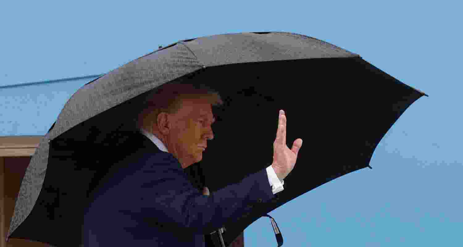 President Donald Trump waves from the stairs of Air Force One on Sunday, as he travels to the Middle East.