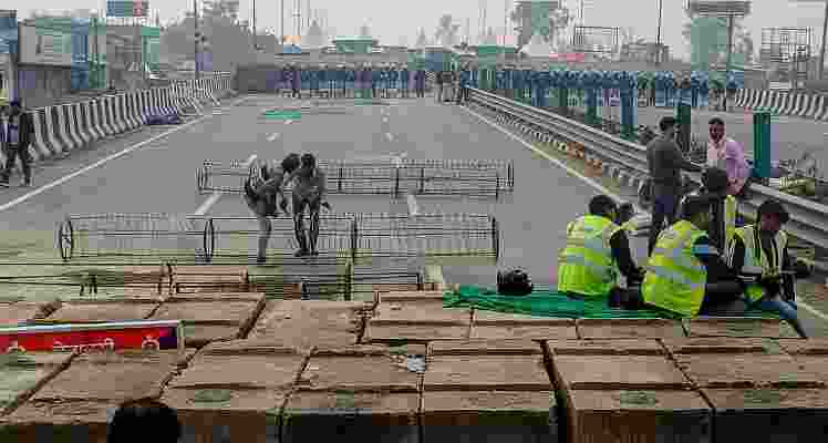 Iron barricades being installed in view of the farmers' march at the Kundli-Singhu border, in Sonipat Iron barricades being installed in view of the farmers' march at the Kundli-Singhu border, in Sonipat
