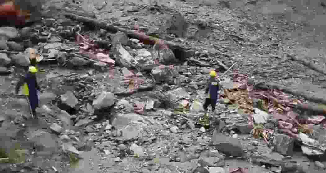 Rescue workers search through debris on the Yamunotri highway near Silai Bend in Uttarkashi after a cloudburst left nine labourers missing and damaged roads, bridges, and farmland on Sunday.