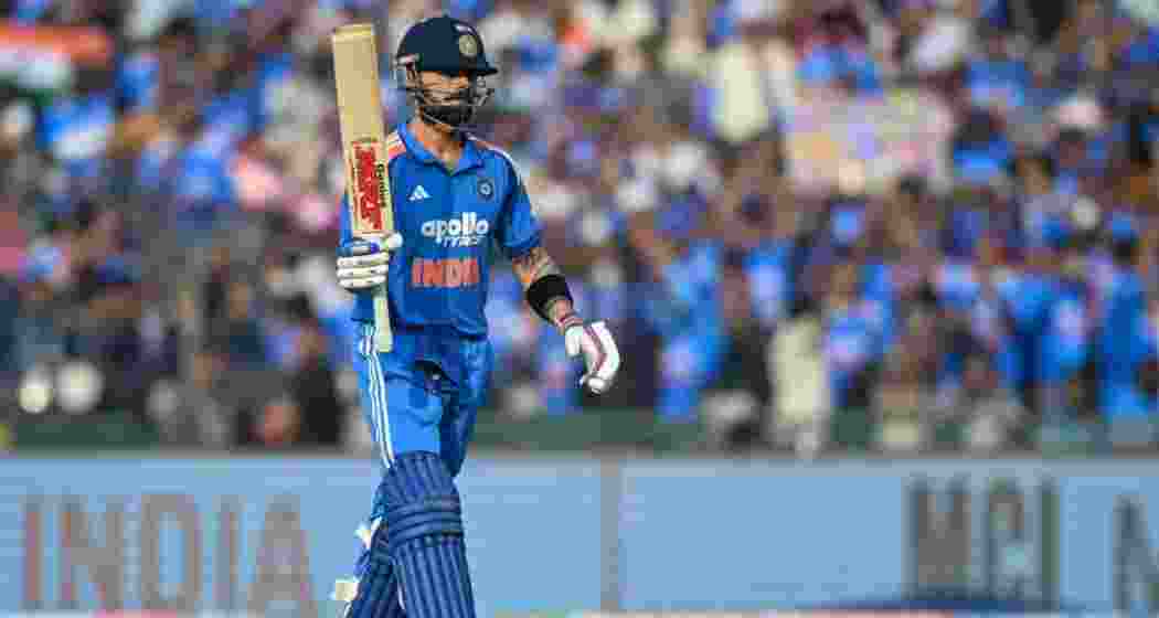 Virat Kohli celebrates a half-century during an ODI international match.