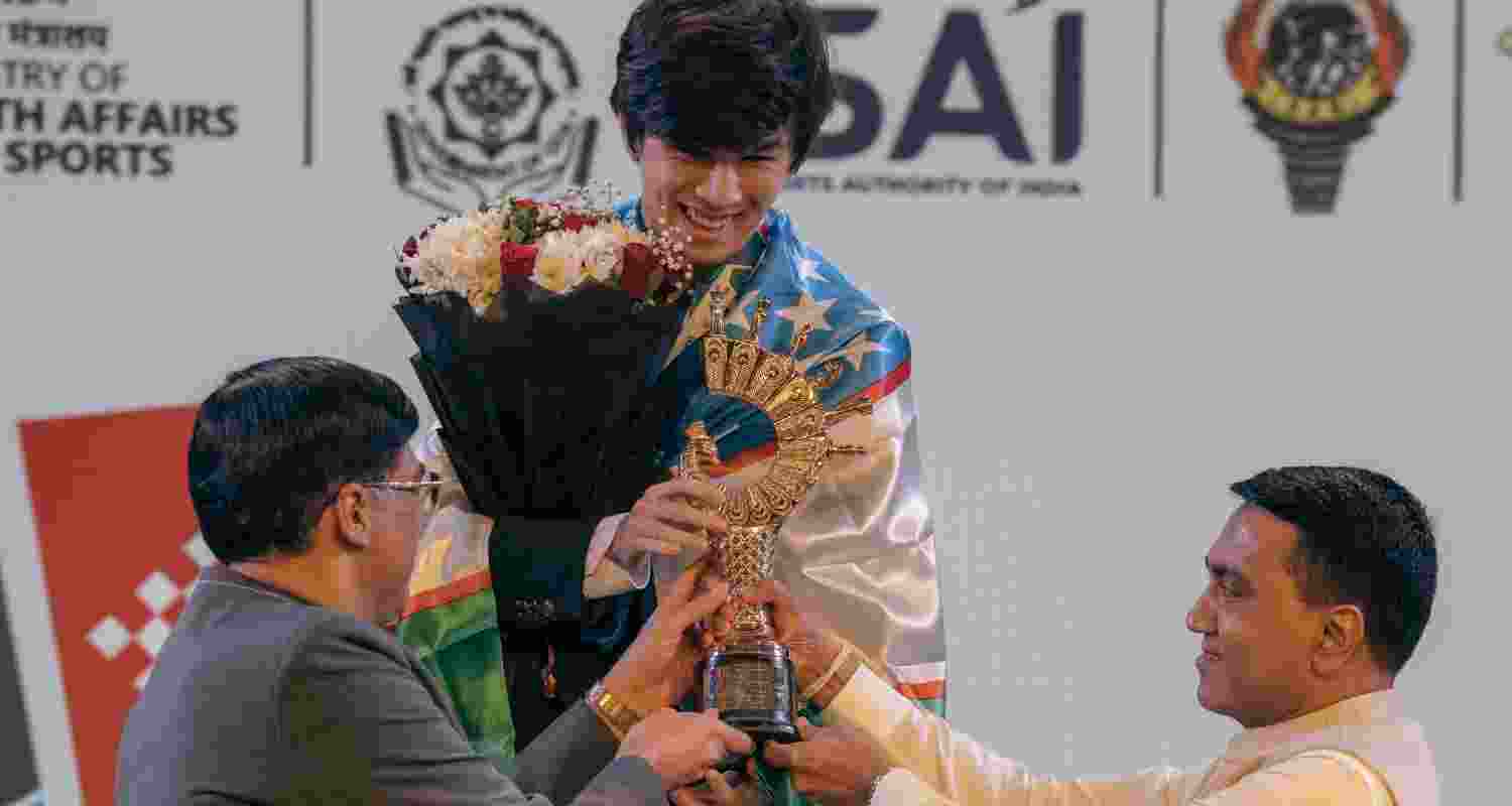 FIDE deputy president Vishy Anand and Goa Chief Minister Pramod Sawant presenting the Viswanathan Anand Cup to Uzbekistan's Javokhir Sindarov in Panaji on Wednesday. FIDE deputy president Vishy Anand and Goa Chief Minister Pramod Sawant presenting the Viswanathan Anand Cup to Uzbekistan's Javokhir Sindarov in Panaji on Wednesday.