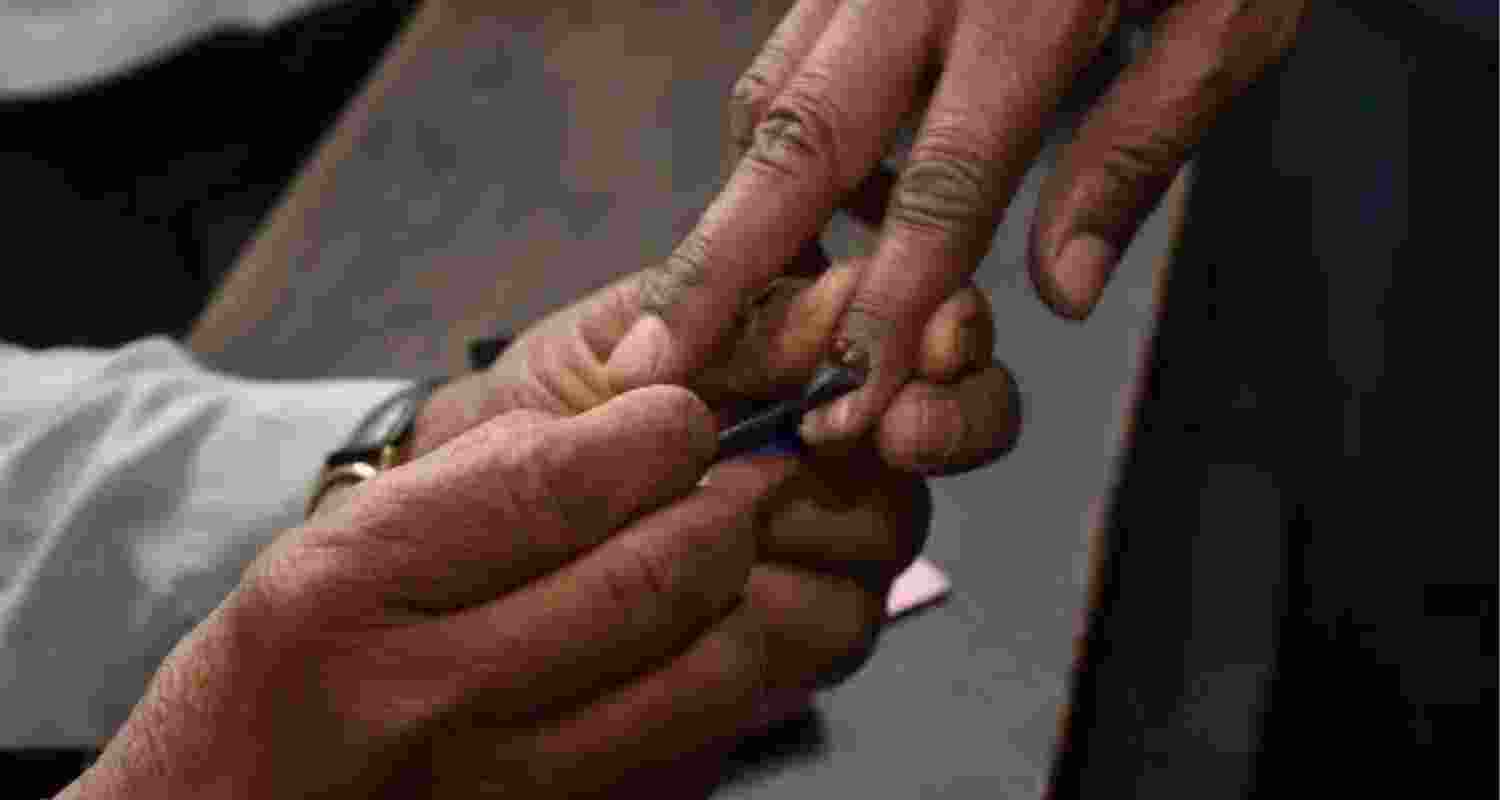 Voter getting inked after casting ballot. Voter getting inked after casting ballot.