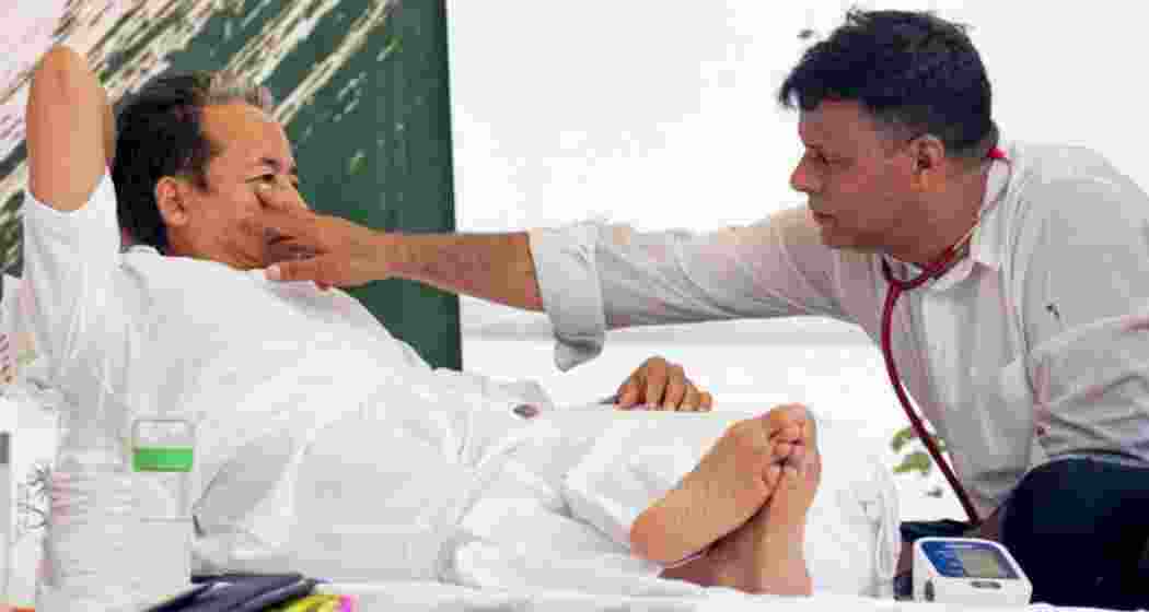 Activist Sonam Wangchuk being attended by a medical professional amid an ongoing hunger strike at Jantar Mantar during a protest over alleged examination irregularities, repeated paper leaks and demands for accountability from the government, in New Delhi, on Wednesday.