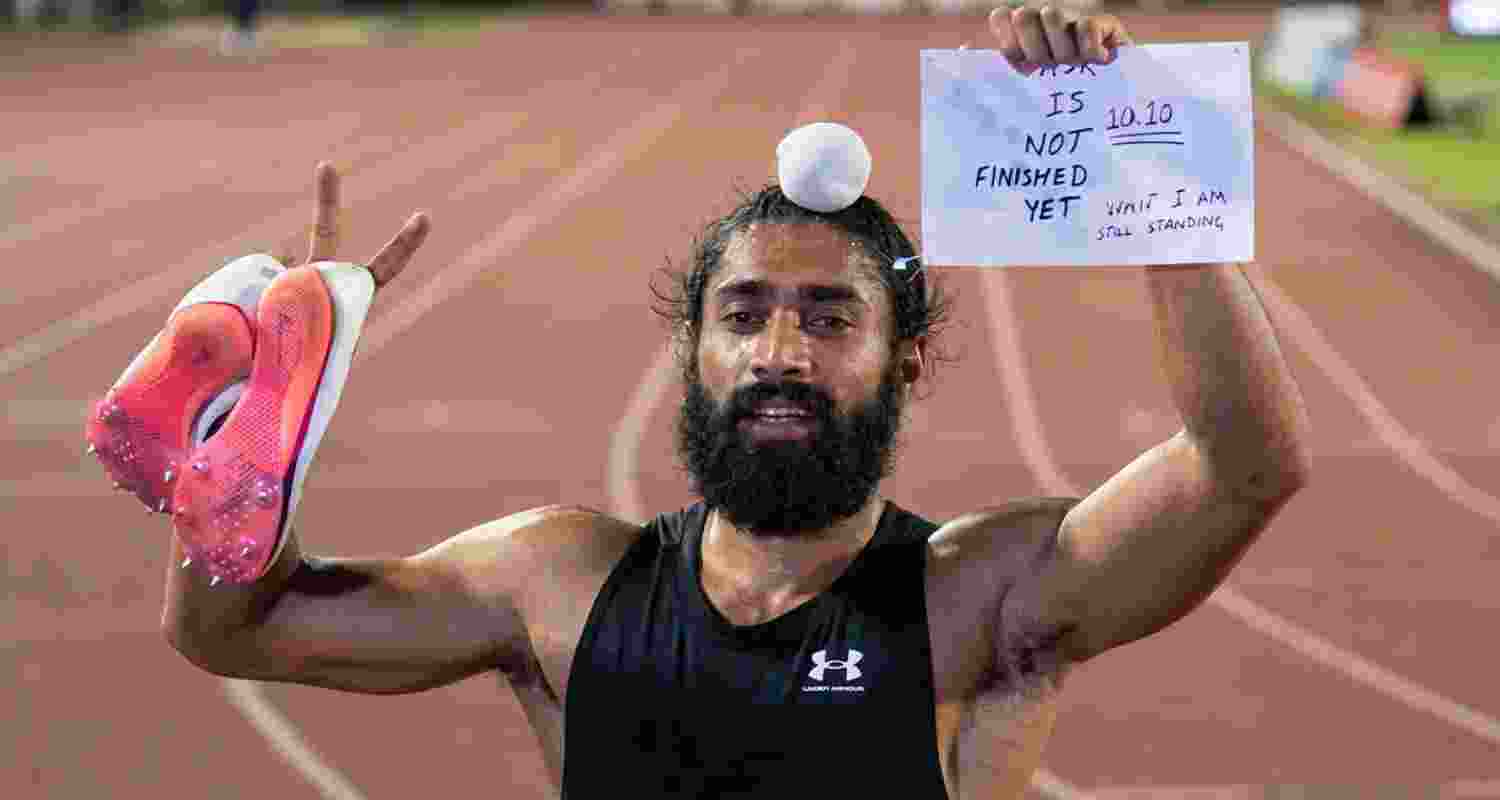 After the race, Gurindervir Singh celebrated holding up his race bib, inscribed with the message, "10.10. Task is not finished yet. Wait, I am still standing."