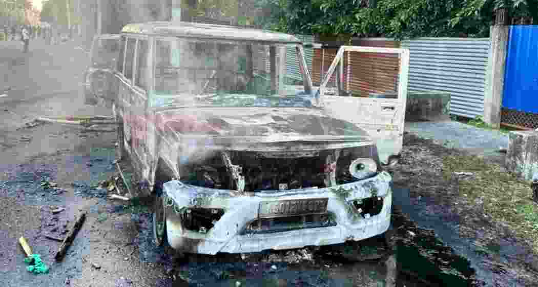 Mangled remains of a police van lie charred after it was set ablaze by a violent mob outside Baksa Jail during protests over Zubeen Garg’s death case.
