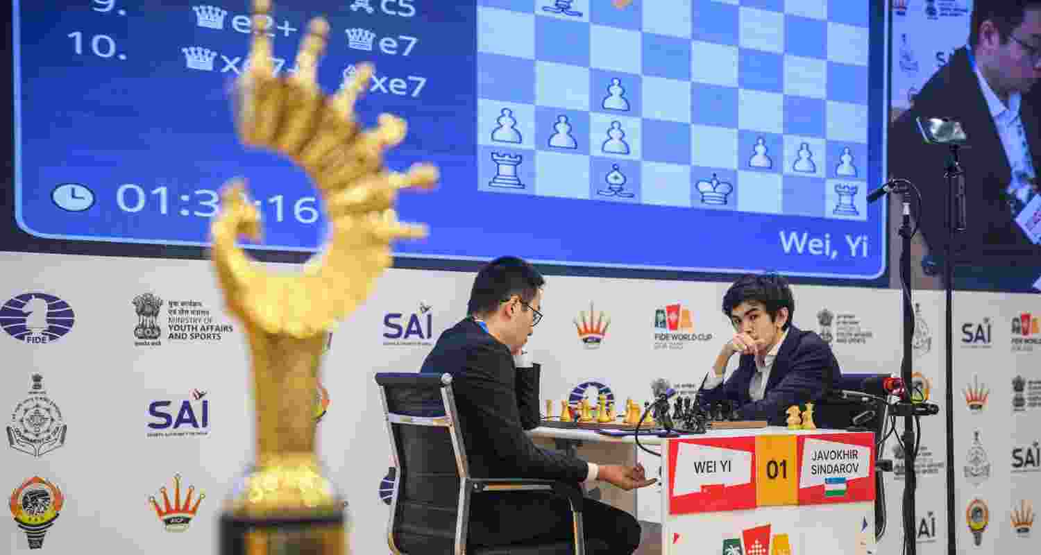 Wei Yi of China and Javokhir Sindarov of Uzbekistan in action during Game 2 of the final at the FIDE World Cup in Panaji on Tuesday.