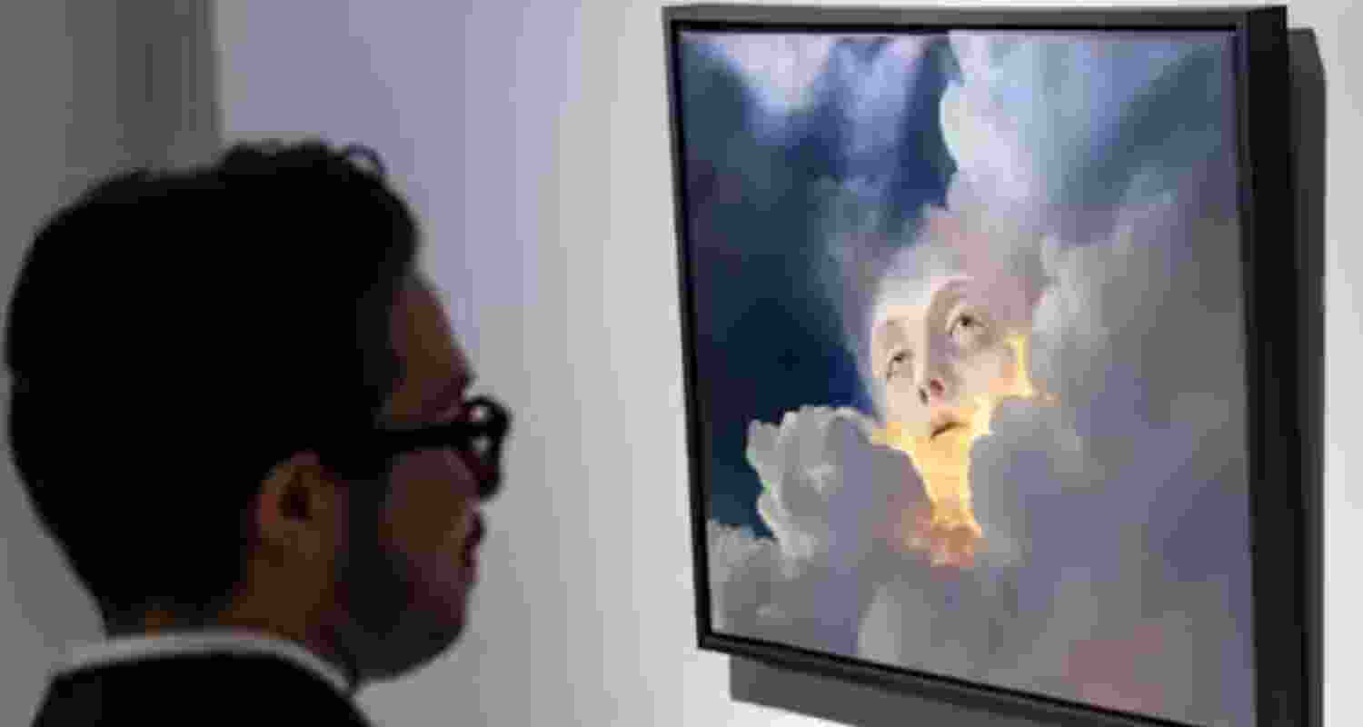 A person looks at an oil painting titled ‘Golden Breath’ generated by Keke, an autonomous AI artist developed by Dark Sando.