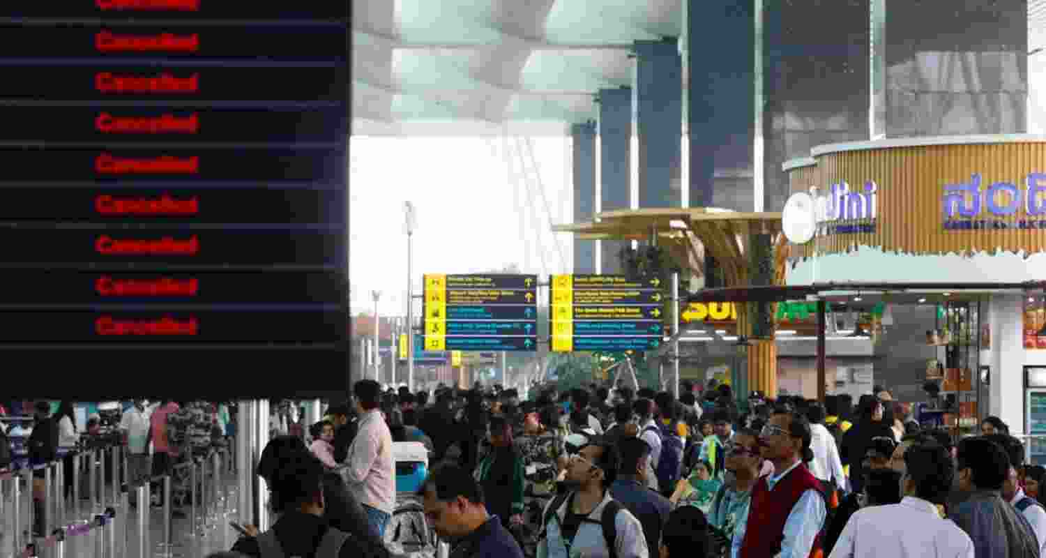 Stranded passengers wait at the airport amid widespread Indigo flights disruptions.