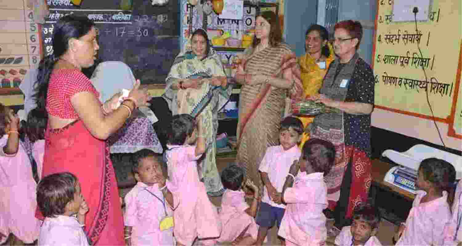 A woman steps up to dig well for children.