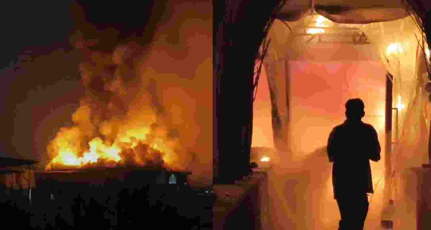 A fire fighter attempts to contain a fire at a nightclub early Sunday, in Arpora, in Goa, India, Sunday. A fire fighter attempts to contain a fire at a nightclub early Sunday, in Arpora, in Goa, India, Sunday.