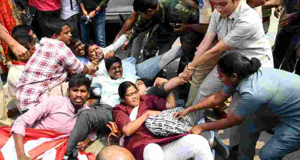 Police personnel stop University of Hyderabad students and faculty members in Hyderabad on Wednesday as they protest the Telangana government’s plan to develop 400 acres of land near the varsity.