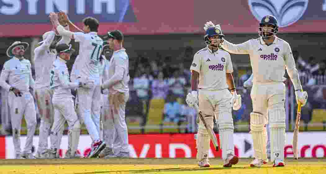 India's Kuldeep Yadav and Jasprit Bumrah walk off the ground as South Africa's players gesture on the third day of the third Test cricket match between India and South Africa at the Barsapara Cricket Stadium in Guwahati on Monday. India's Kuldeep Yadav and Jasprit Bumrah walk off the ground as South Africa's players gesture on the third day of the third Test cricket match between India and South Africa at the Barsapara Cricket Stadium in Guwahati on Monday.