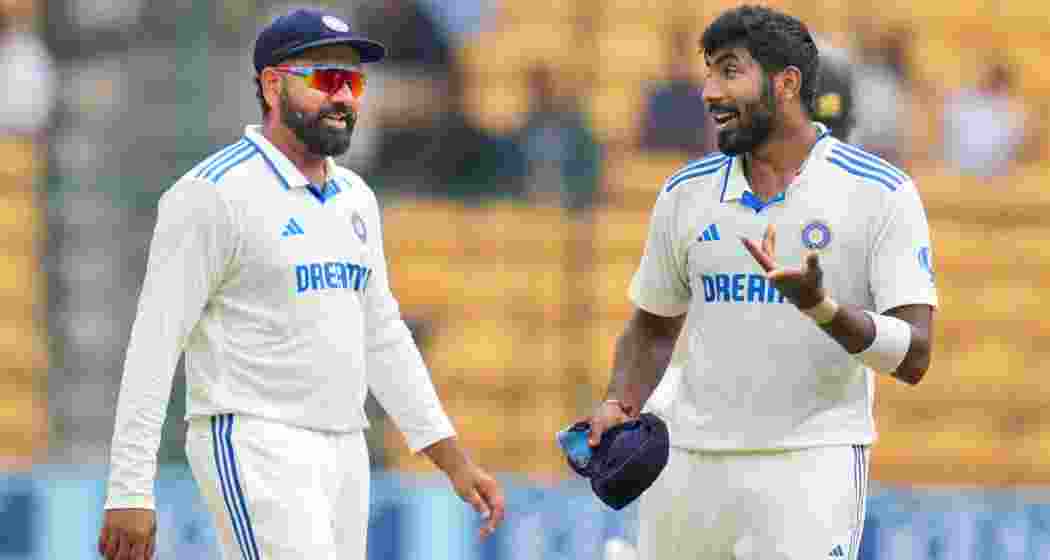India's Rohit Sharma and Jasprit Bumrah during the fifth day of the first test cricket match between India and New Zealand.
