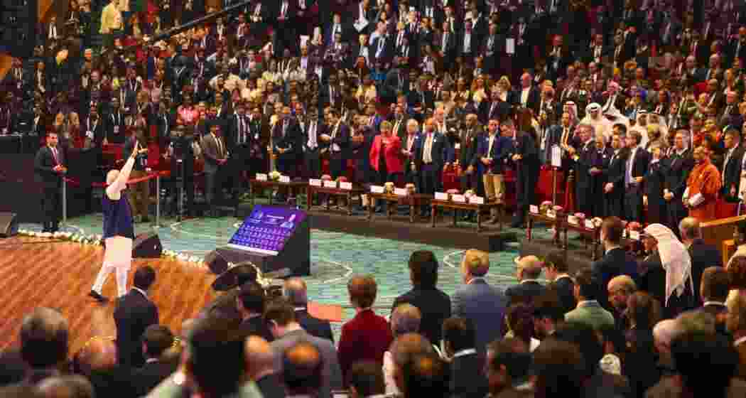 Prime Minister Narendra Modi waves to global leaders and stakeholders during the AI Impact Summit in New Delhi.