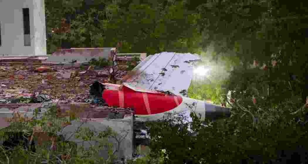 Remains of the Air India plane that crashed moments after taking off from the Ahmedabad airport, lies on a building in Ahmedabad, Thursday. Remains of the Air India plane that crashed moments after taking off from the Ahmedabad airport, lies on a building in Ahmedabad, Thursday.
