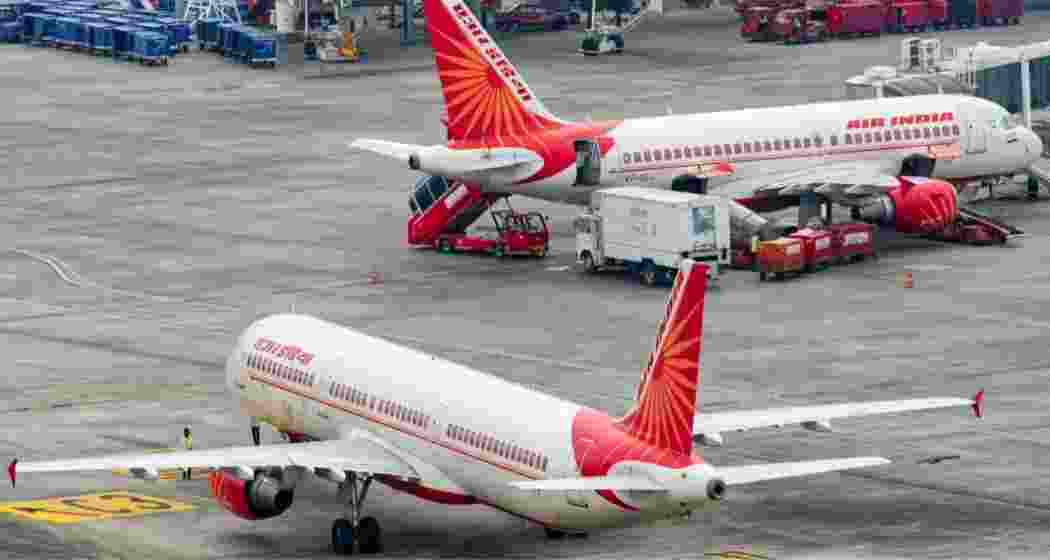 An Air India aircraft rests on the tarmac.