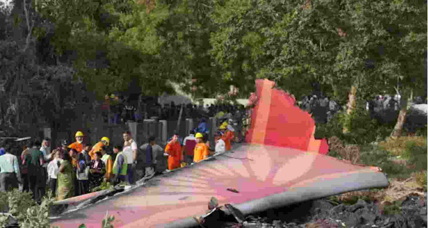 A firefighter stands next to the crashed Air India Boeing 787-8 Dreamliner aircraft in Ahmedabad, India, June 13.