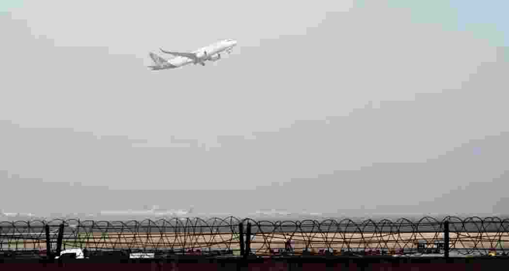 An aircraft takes flight as torrential rain grounds dozens of flights and paralyses traffic in the capital. 