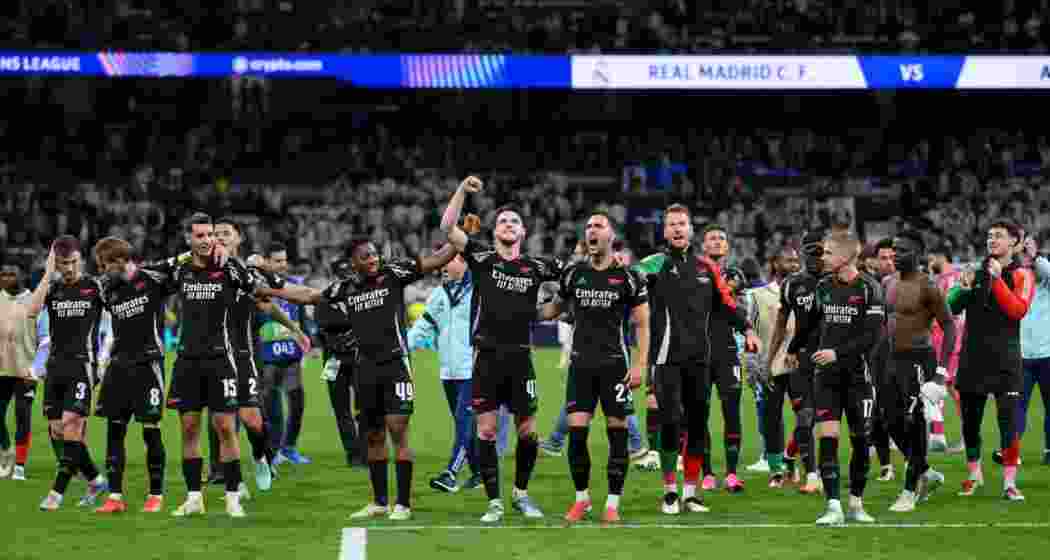 Arsenal players celebrate at the Santiago Bernabeu after defeating Real Madrid 2-1, securing a 5-1 aggregate win and a long-awaited place in the UEFA Champions League semi-finals.