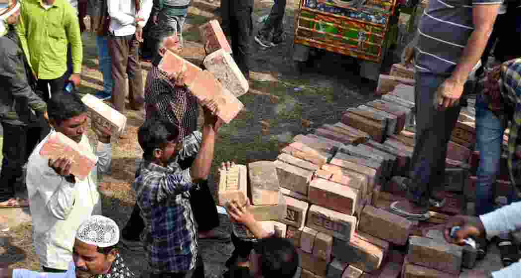 People carry bricks in view of former TMC MLA Humayun Kabir's plan to lay the foundation stone for a mosque, modelled on Ayodhya’s Babri Masjid, at Rejinagar in West Bengal’s Murshidabad district.