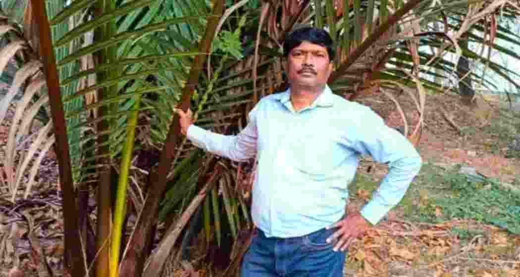 Geography teacher Bhaskar Mandal stands beside a palm tree in Hooghly’s Pandua, where he has planted over 75,000 of them to shield villagers and farmers from deadly lightning strikes.