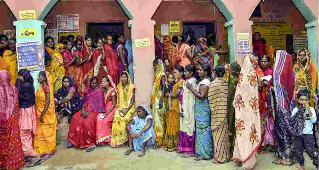  People wait in queues to cast their votes at a polling station during the second and final phase of the Bihar Assembly elections, in Jehanabad on Tuesday.