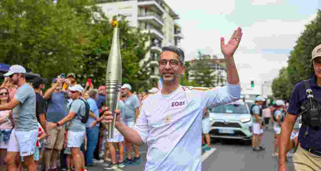 Abhinav Bindra carries the Olympic flame during the Paris 2024 torch rally.