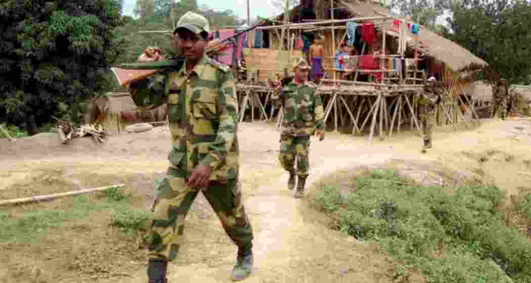 BSF men patrolling an unfenced stretch along India—Bangladesh border.