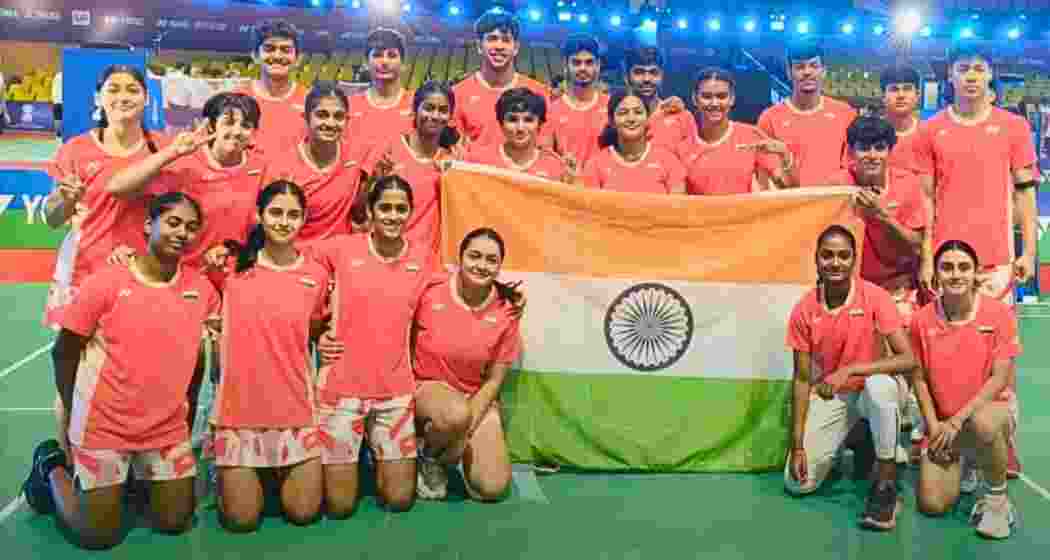 India’s junior shuttlers display the national flag after clinching their maiden mixed team bronze medal at the BWF World Junior Championships in Guwahati.
