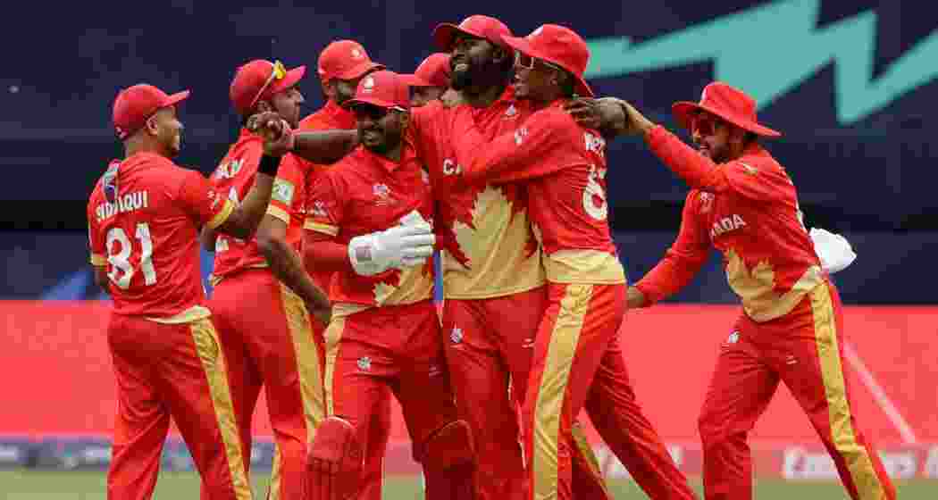 Canada's Aaron Johnson, third from right, is congratulated by teammates after taking the catch to dismiss Ireland's Curtis Campher for 4 runs during an ICC Men's T20 World Cup cricket match at the Nassau County International Cricket Stadium in Westbury, New York on Friday, June 7, 2024.
