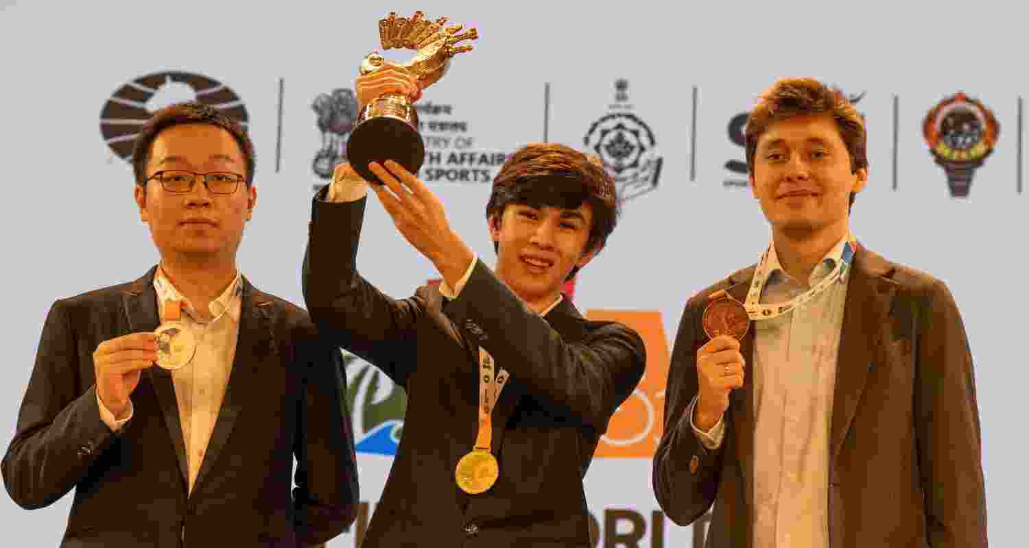Javokhir Sindarov lifting the Viswanathan Anand Cup after beating Wei Yi of China (left), while Andrey Esipenko (extreme right) finished as the second runner-up at the FIDE World Cup in Panaji on Wednesday.