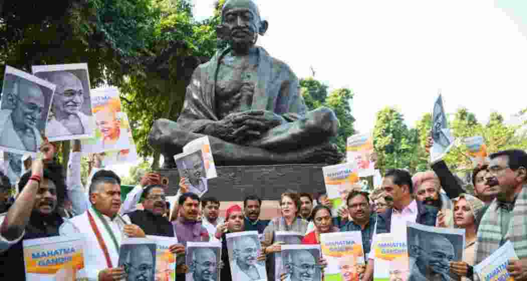 Congress workers stage a protest against the repeal of MGNREGA in New Delhi on Saturday.