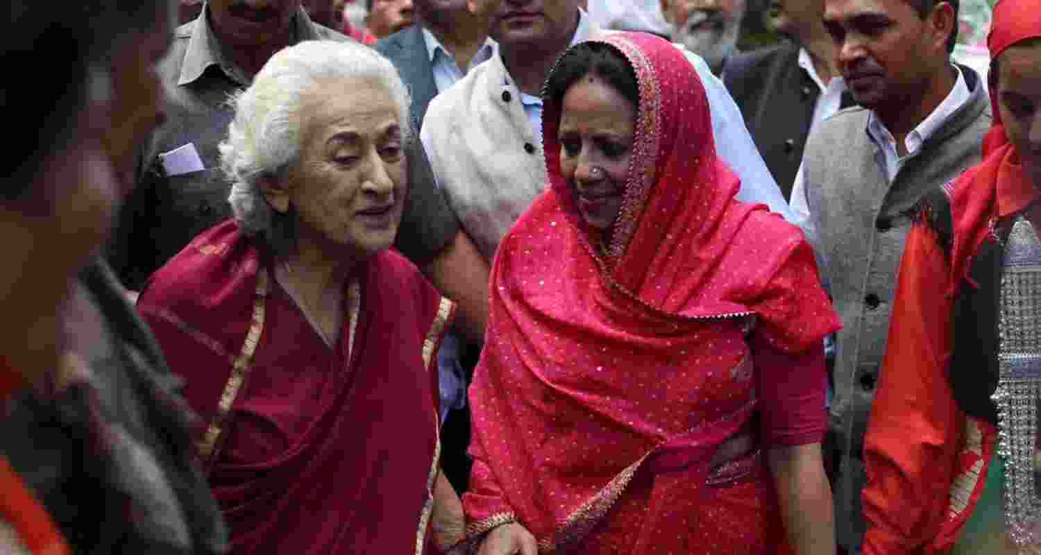 Congress veteran leader Vidya Stokes (left) meets the public during a rally ahead of the elections.