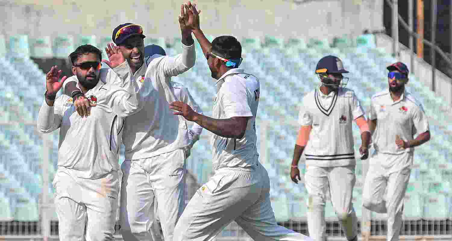 Mumbai’s Shams Mulani celebrates with Suryakumar Yadav and others after taking the wicket of Haryana’s Himanshu Rana on the second day of a Ranji trophy quarterfinal cricket match between Haryana and Mumbai, at the Eden Gardens, in Kolkata, Sunday.