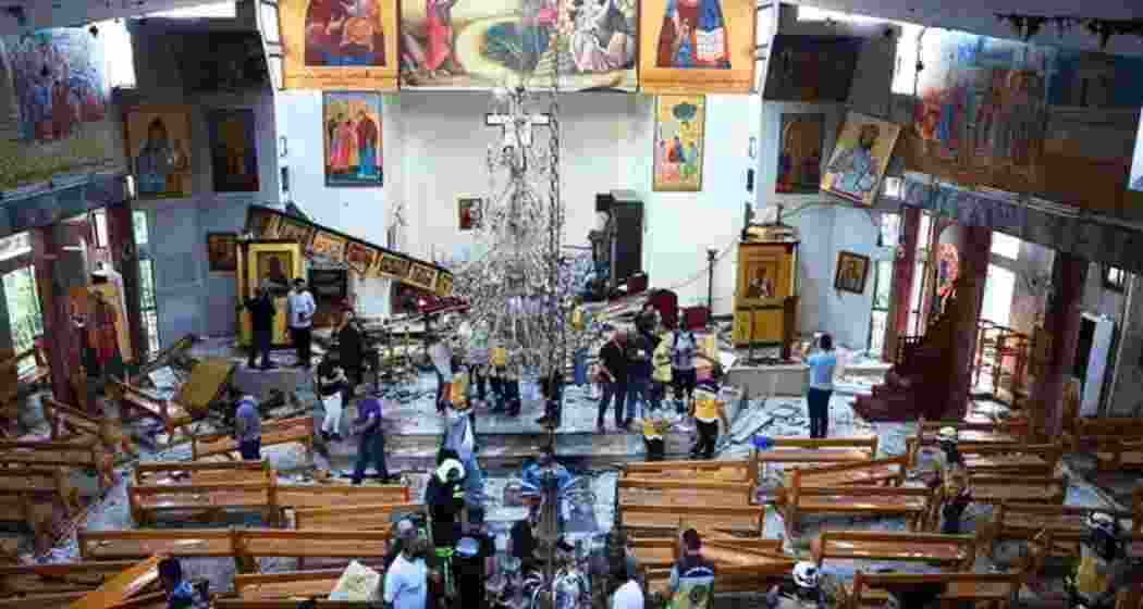 Officials examine the aftermath of the suicide bombing at Mar Elias Church in Damascus, where 20 worshippers were killed and over 50 injured. Authorities suspect ISIS involvement