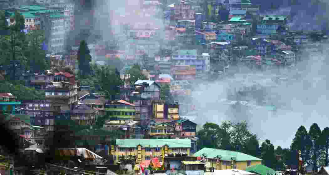A cloud of smoke engulfs a congested Darjeeling street, situated at 6,700 feet, in the popular West Bengal hill station.