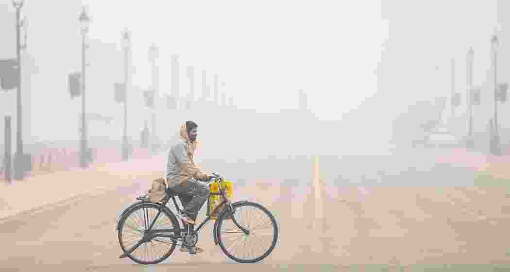 A commuter at Kartavya Path amid morning fog, in New Delhi, Friday, Jan. 3, 2025. A thick blanket of fog engulfed the national capital on Friday morning, as visibility dropped to zero in some areas, with the weather department predicting cloudy skies for the day. 
