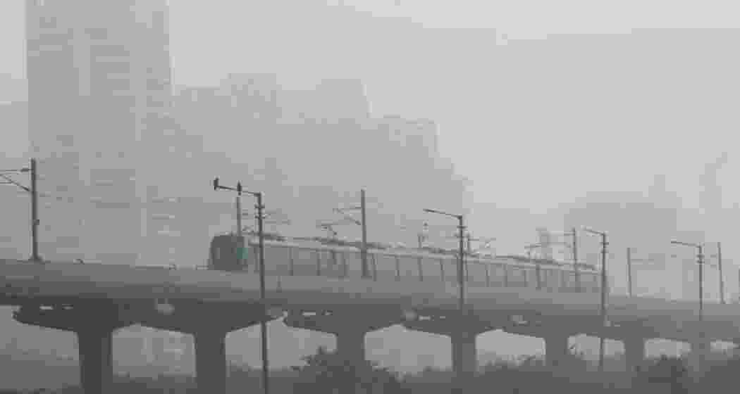 A Delhi Metro train glides through thick fog. The weather conditions have been affecting visibility and transport across the city as cold wave conditions persist in the capital. A Delhi Metro train glides through thick fog. The weather conditions have been affecting visibility and transport across the city as cold wave conditions persist in the capital.