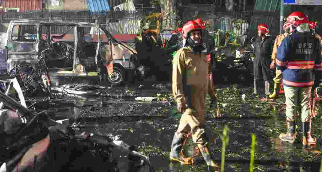 Firefighters at the spot after a blast occurred in a parked car near Red Fort, leaving multiple vehicles in flames, in New Delhi on Monday.