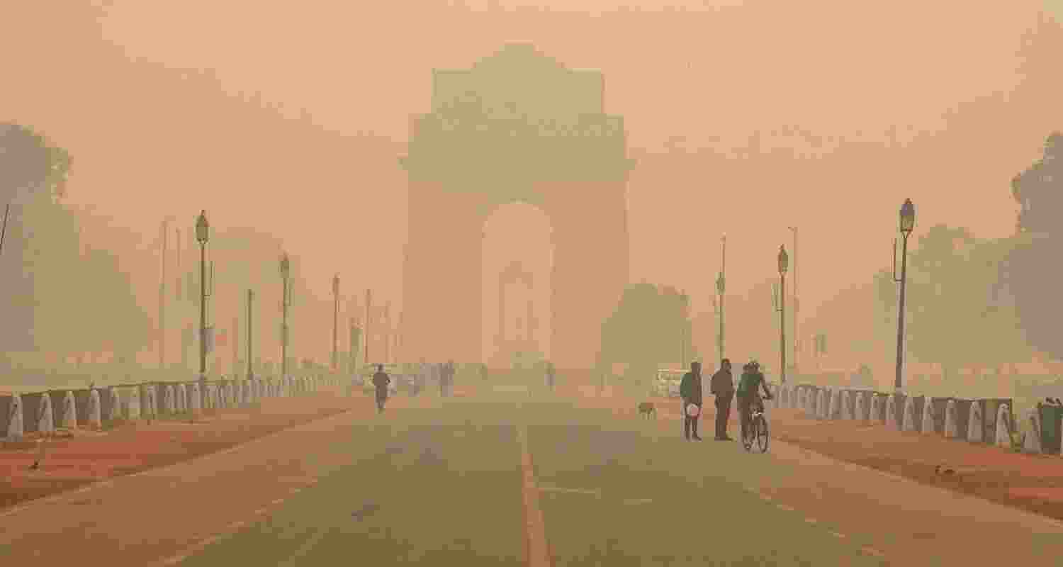 A thick haze envelops the India Gate, highlighting the severe air pollution in Delhi.