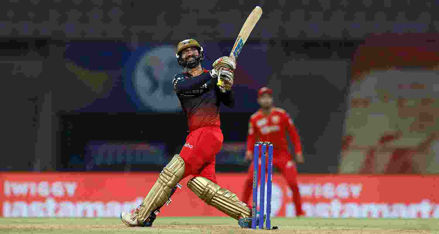Batsman Dinesh Karthik hits a sixer during a match against Punjab Kings in IPL 2023.