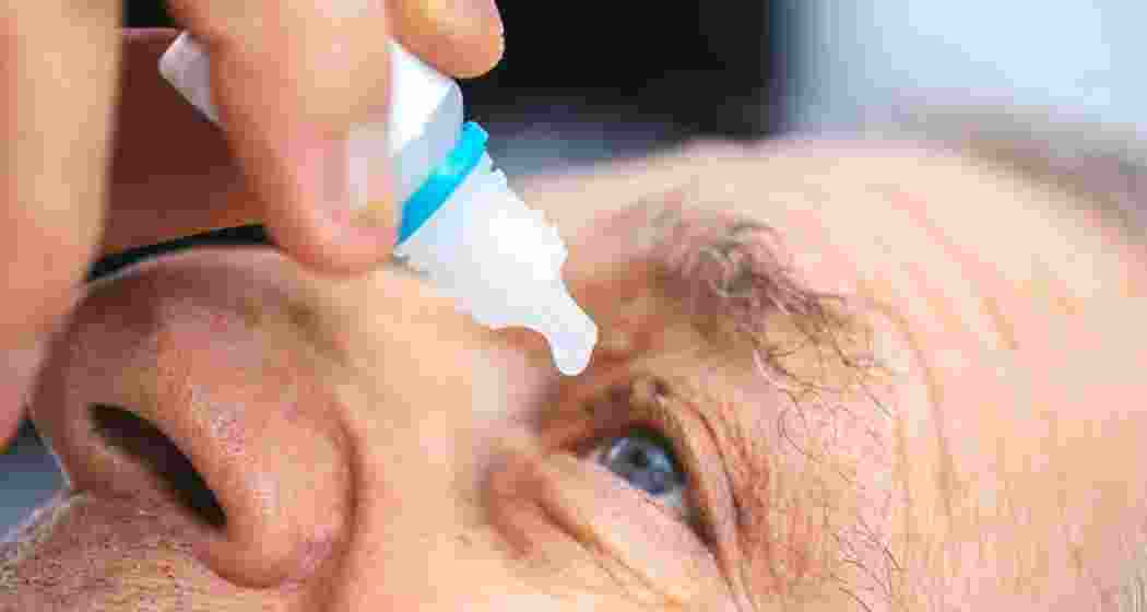 A participant undergoes a near vision test after using experimental eye drops for presbyopia. 