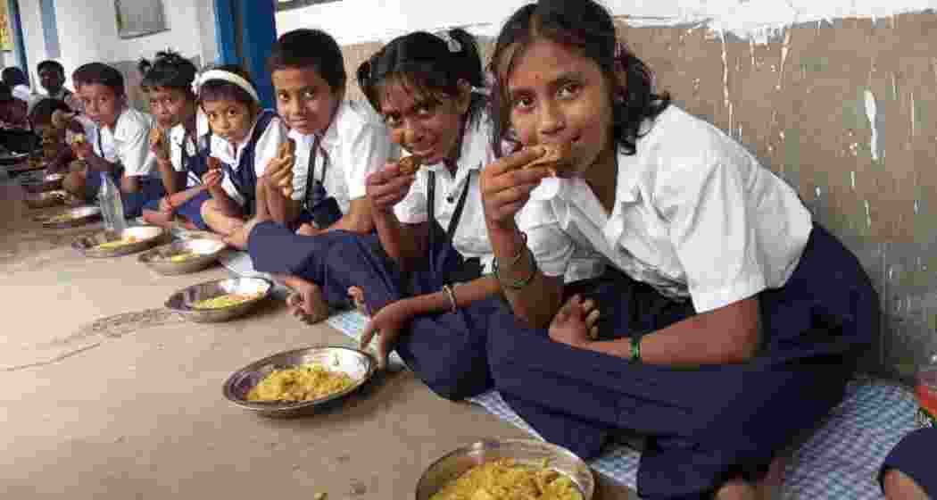 Students at Ulubari Bermal Primary School enjoy a special mid-day meal featuring hilsa. 