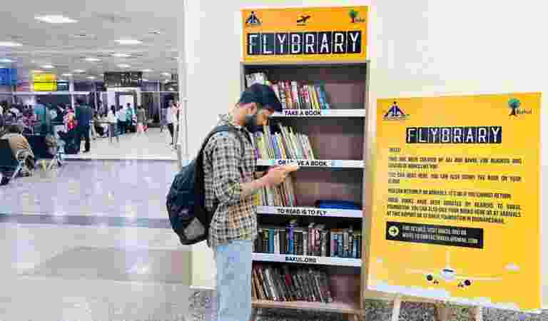 A book lover browses through books at “Flybrary”, India’s first ‘take a book library’, at the Bhubaneswar airport.