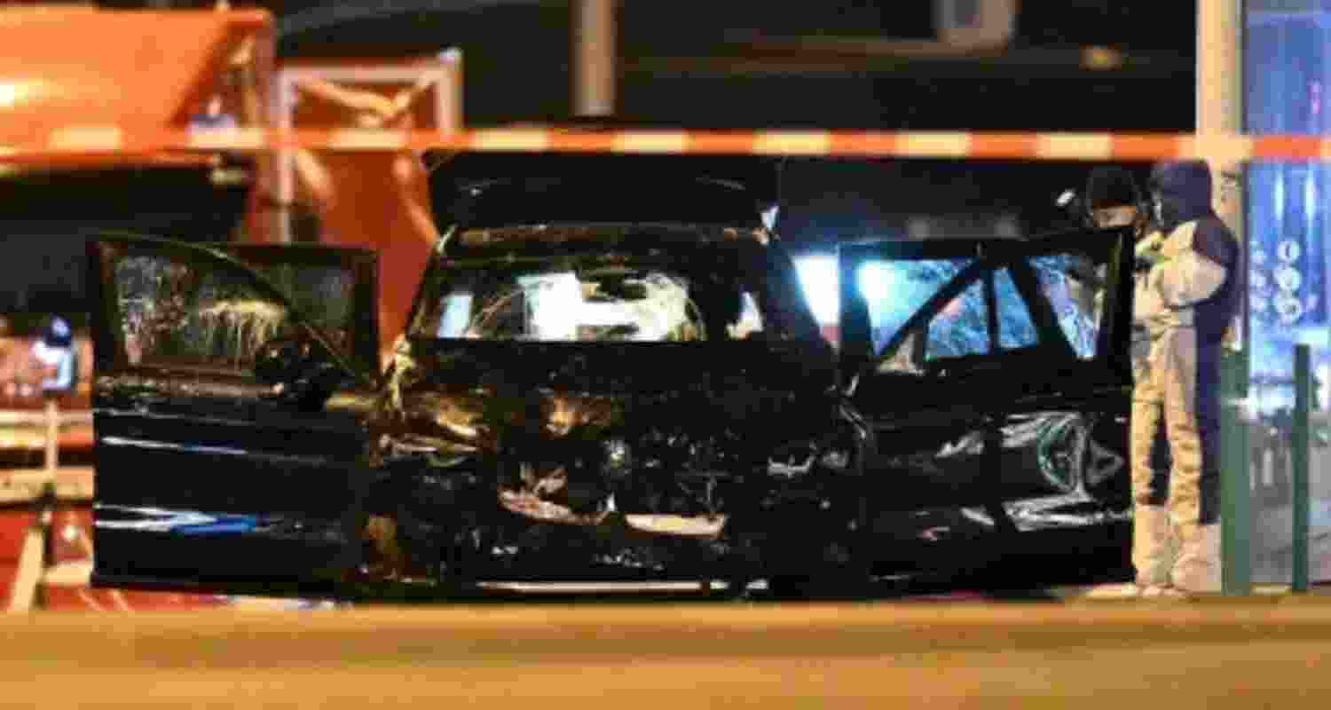 Forensics work on a damaged car sitting with its doors open after the driver plowed into a busy Christmas market in Magdeburg, Germany, early Saturday. 