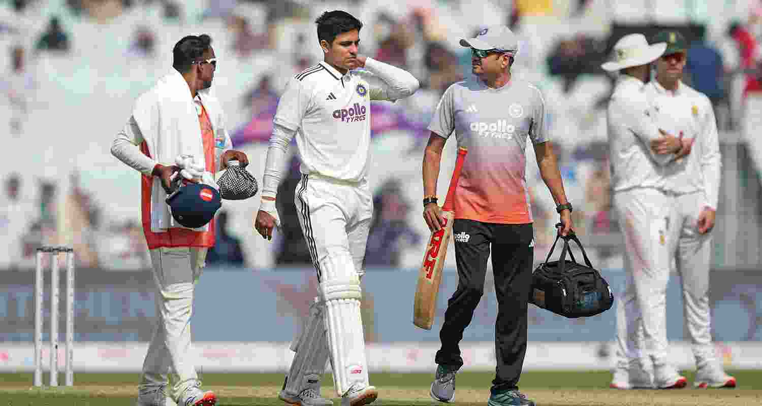 Captain Shubman Gill walks off the field after being retired hurt during the second day of the first Test cricket match of a series between India and South Africa, at the Eden Gardens, in Kolkata.