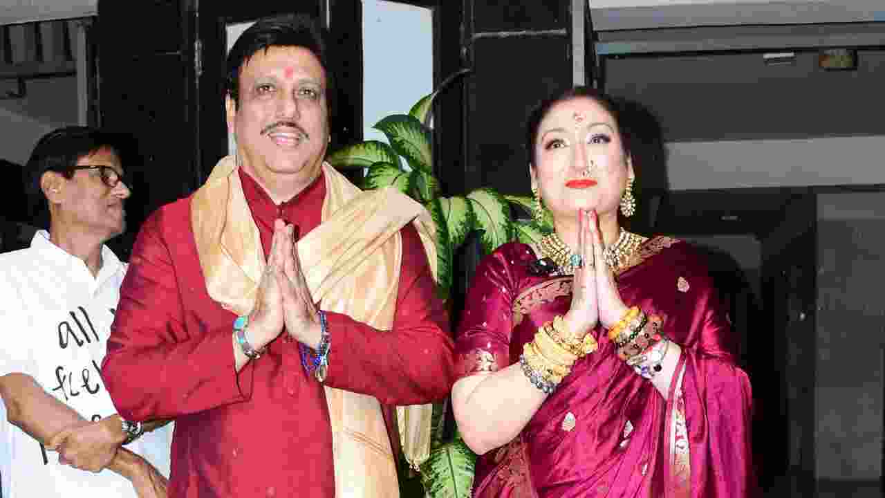 The couple was all smiles as they distributed sweets to the paparazzi gathered outside their home.