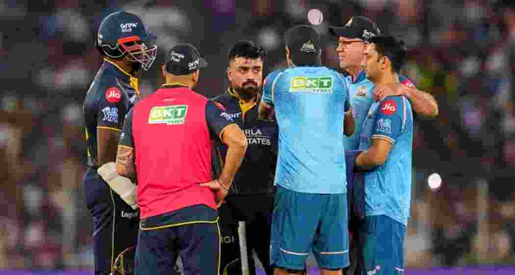 Gujarat Titans' captain Rashid Khan, back centre, and Kagiso Rabada, left, interact with head coach Ashish Nehra, front centre, batting coach Matthew Hayden, back right, and others between overs during an Indian Premier League (IPL) 2026 T20 cricket match between Gujarat Titans and Rajasthan Royals in Gujarat. (Photo: PTI)