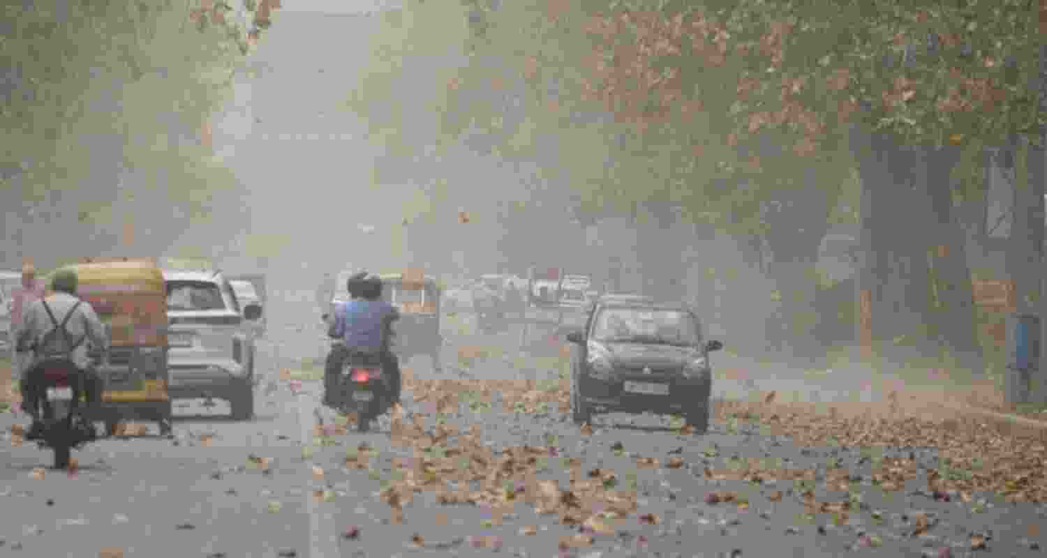 Vehicles ply on road amid a dust storm, in New Delhi. 